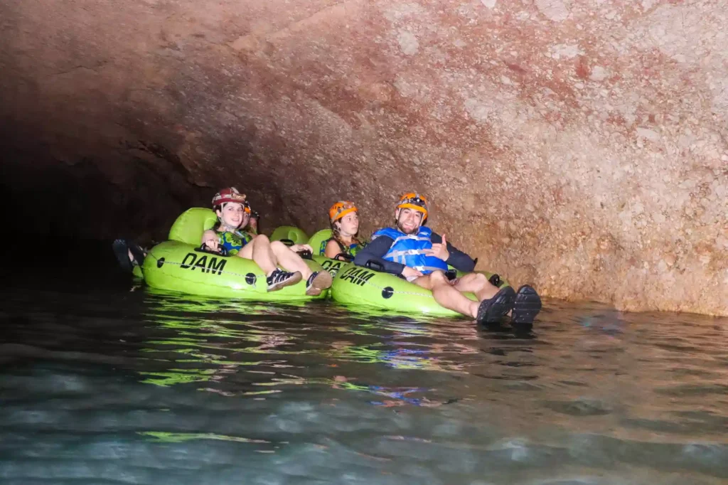 Guests cave tubing through Nohoch Che'en at Jaguar Paw in Belize