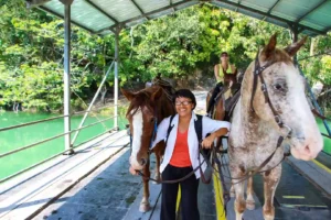 Guests horseback riding toward Xunantunich in western Belize