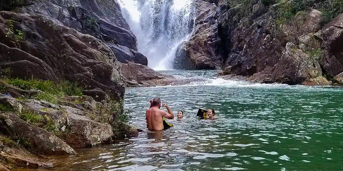Family enjoying a swim at Big Rock Falls in Mountain Pine Ridge, Belize