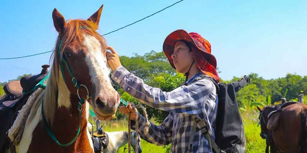 Guests horseback riding with a St. Leonard’s guide at San Lorenzo Farm near San Ignacio, Belize